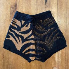 Soft Knit Dual Tone Tiger Print Shorts With Adjustable Waist Tiger Print Shorts, Casual Black Knit Bottoms, Black Knit Bottoms For Spring, Brown Bottoms For Fall Vacation, Cozy Black Bottoms For Fall, Black Knit Bottoms For Loungewear, One Size Black Bottoms For Fall, Black Casual Bottoms, One Size, Tiger Shorts