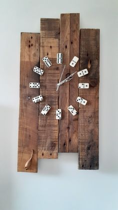 a clock made out of wood with dominos on it