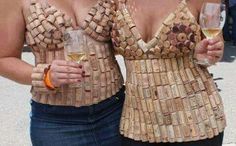 two women standing next to each other holding wine glasses