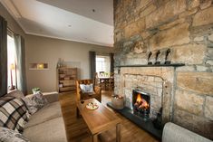 a living room filled with furniture and a fire place