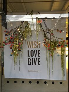 a sign that says wish love give hangs in the window