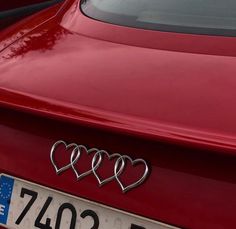 three hearts on the front of a red car