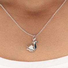 Crafted from 925 sterling silver this stunning swan charm necklace features smooth polished surfaces with angular edges to mimic folds of paper and gives it a subtle geometric style. Inspired by the Japanese art of paper folding, this three-dimensional origami swan design will make an unusual and fun jewellery gift to symbolise elegance, beauty and balance.  All our charms attach with a clip-on clasp and are compatible with all other leading charm jewellery brands. Simply clip-on or slide-on to Elegant Silver Necklace With Bird Shape, Swan Jewelry Necklace, Silver Flower-shaped Charm Necklace For Her, Swan Design, Origami Swan, Swan Necklace, Sterling Silver Wing-shaped Necklace, Silver Bird-shaped Sterling Silver Necklace, Jewellery Gift