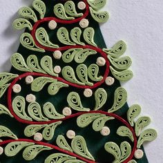 a christmas tree made out of green and red thread with white buttons on the top