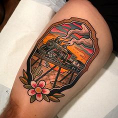 a person with a tattoo on their leg that has an image of a train coming out of it