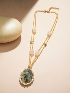 Embark on an artistic journey with our jade necklace, a masterpiece that intertwines Polki, 22kt gold plated chains, micro plated brass rings, fresh water pearls, and intricately carved jade drops. This exquisite piece is not just jewelry; it's a canvas of craftsmanship and creativity. Ideal for cultural events, festive occasions, and artistic soirées, where each element tells a unique story, this necklace is a testament to the fusion of tradition and contemporary artistry. Finish: 22KT Gold Pla Gold Necklaces With Oval Pendant And Stones, Gold Oval Gemstone Beads Jewelry, Oval Gold Necklaces With Stones, Oval Gold Necklace With Stones, Gold Oval Jewelry With Gemstone Beads, Gold Double Strand Jewelry With Natural Stones, Gold Jade Jewelry With Stones, Fine Gold Jewelry With Jade, Exquisite Gold Jewelry With Stones