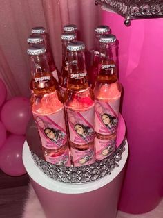 there are six bottles of pink soda on the cake