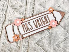 a wooden sign that says mrs wright with flowers on it