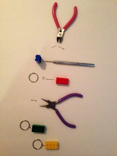 some tools are laying out on a white surface with scissors and other items around them