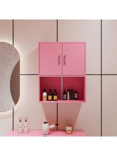 a bathroom with pink cabinets and white tiles on the wall, along with soap bottles