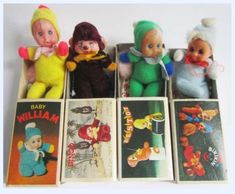 six vintage baby doll toys are lined up