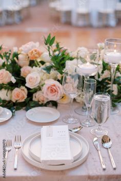 the table is set with silverware, plates and napkins for an elegant dinner