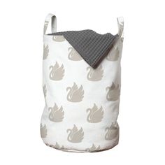 a white and gray swan print storage bag with a grey knitted hat on top