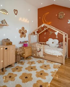 a child's bedroom with an orange wall and white rugs on the floor