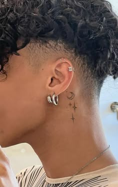 a close up of a person with ear piercings on their ears and behind her ear