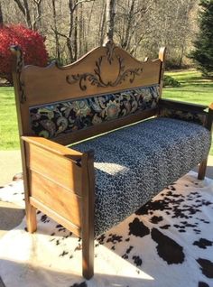 a wooden bench sitting on top of a cowhide rug