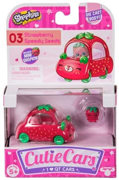 a pink toy car with strawberry on the top and green trimmings in it