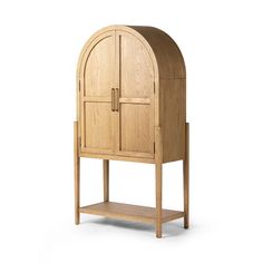 a wooden cabinet with an arched door and shelf on the bottom, against a white background