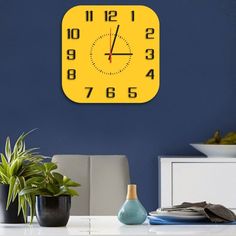 a yellow clock on the wall above a dining room table with two vases and a potted plant