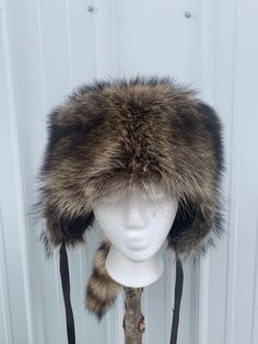 Nebraska raccoon fur hat. Made here in our shop. Each hat is made to order.Raccoons are caught in Nebraska by nuisance trappers and are shipped to us where we tan and make into items. We have found that the Midwest raccoons have the best color and fur in the country. The hat is lined and has ear flaps that can be tied up. These are beautiful hats. Concealed Carry Belt, Raccoon Hat, Kinds Of Hats, Hat Aesthetic, Hunting Trip, Trapper Hats, Beautiful Belts, Hat Handmade, Best Color