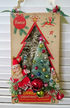 an old fashioned christmas tree is displayed in front of a cardboard sign that says time for christmas