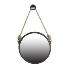 a round mirror hanging from a rope