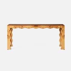 a wooden table with an intricate design on the top and bottom, against a white background