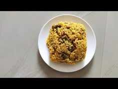 a white plate topped with rice and nuts