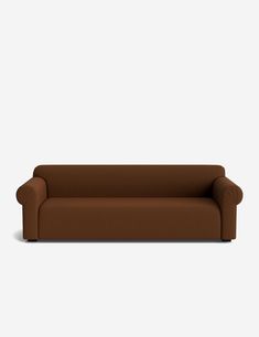 a brown couch sitting on top of a white floor