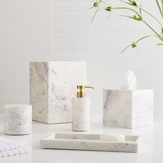 marble bathroom accessories including soap dispenser, toothbrush holder and tissue dispenser