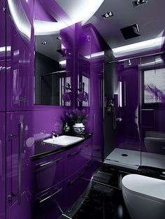 a bathroom with purple walls and black counter tops