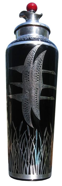 a black and silver urn with an image of a bird on it's side