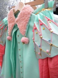 some very pretty dresses hanging on a rack