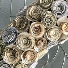 a bunch of rolled up paper flowers sitting on top of a table