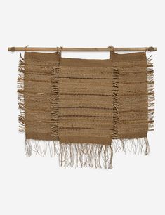 a wall hanging with fringes on it