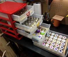 an assortment of crafting supplies sitting on a workbench with tools in it