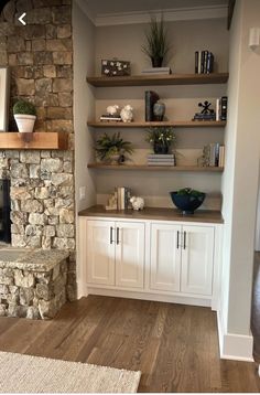 a living room filled with furniture and a fire place in front of a stone fireplace