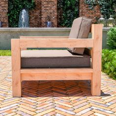 a wooden bench sitting on top of a brick patio