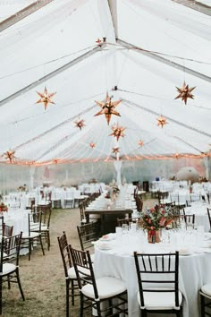 a large tent with tables and chairs set up for an event