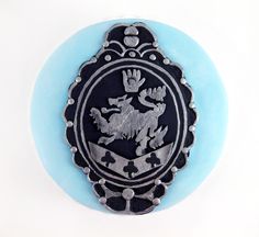 a blue and black plate with a lion on it