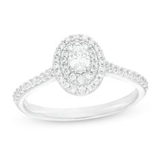 a white gold ring with an oval shaped diamond and pave set diamonds around the band