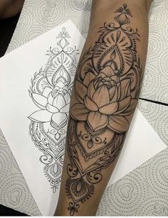 a woman's leg with a tattoo on it that has a flower and heart in the middle