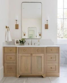 a bathroom with two sinks and a large mirror