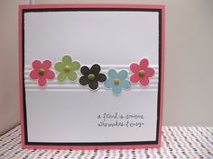 a card with flowers on it sitting on a table