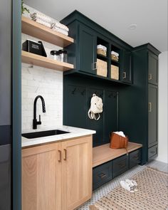 a kitchen with green cabinets and white walls