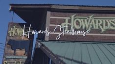 the sign for howard's steakhouse in front of a building with green roofing