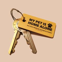 a keychain with a tag that says, my pet is home alone