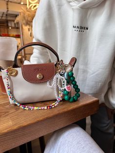 Repurpose Louis Vuitton Purses, Summer Bags Aesthetic, Purse Accessories Aesthetic, Bag With Charms Aesthetic, Bag Charms Aesthetic 2024, Purse Accessories Ideas, Bag Charm Trend 2024, Bag Charm Aesthetic, Mini Purse Aesthetic