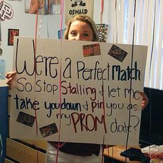 a woman holding up a sign that says we're a perfect math so stop stalling let me take you down and pin it as prom date?