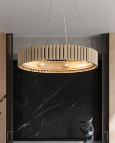 a modern chandelier hangs from the ceiling in a room with marble walls and flooring